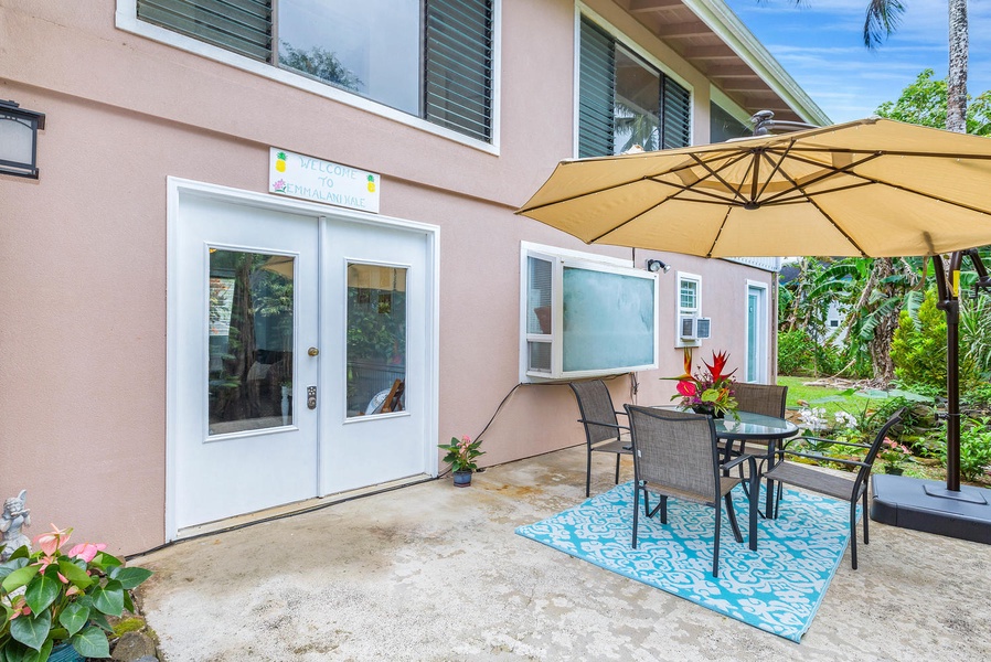 Charming outdoor lanai area with a bistro-style setup, perfect for enjoying your morning coffee or dining al fresco.