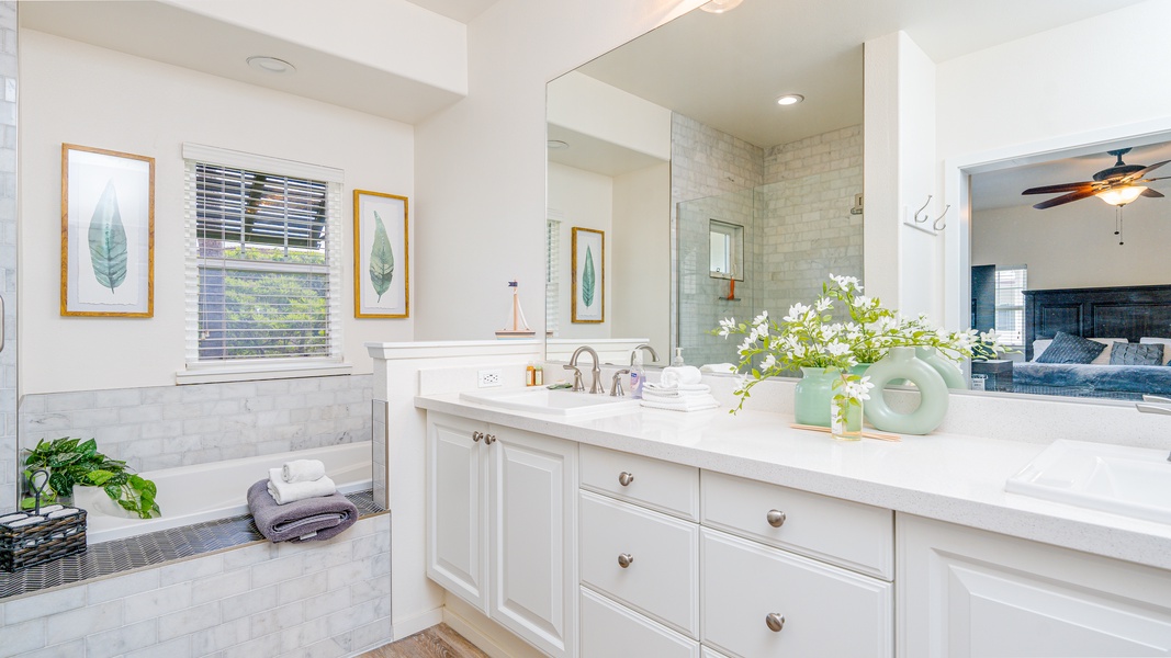The primary guest bathroom features a soaking tub and walk-in shower.