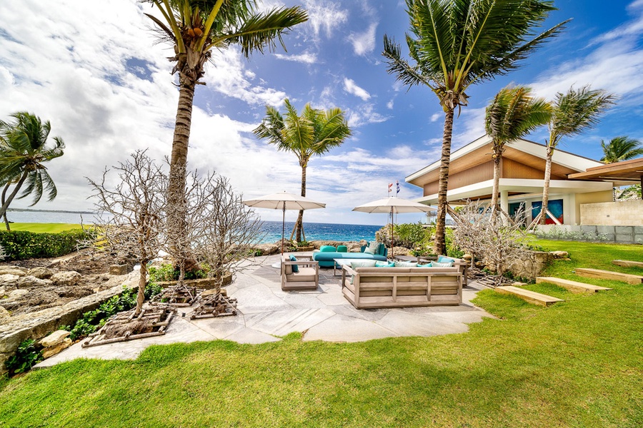 Gather on the oceanfront patio, an idyllic setting with comfortable seating and stunning views.