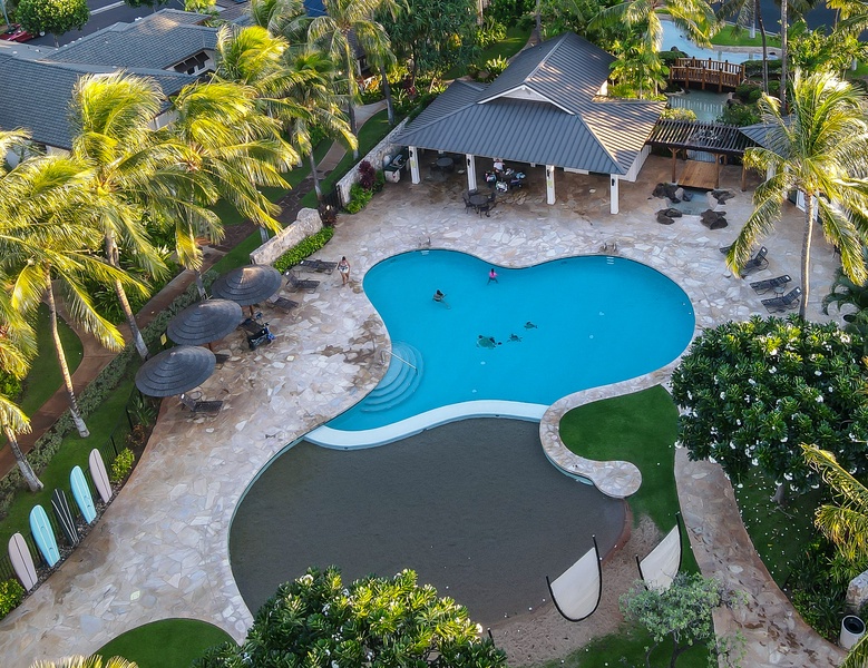 An aerial view of the lounge chairs and cabana by the pool.