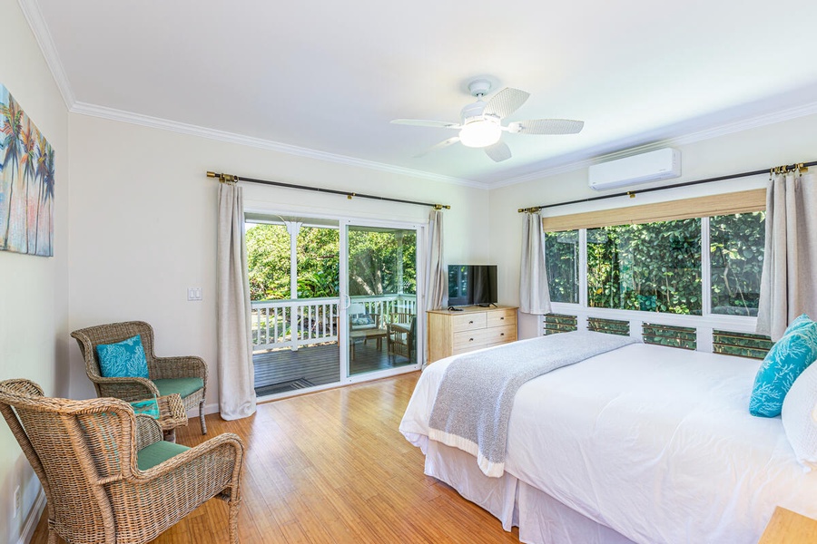 The primary bedroom has a Cal King bed, flat-screen TV, and a dresser, boasting a direct access to a private lanai