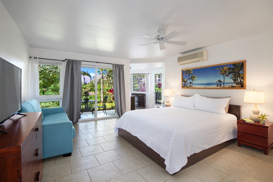 An upstairs primary suite at Villas of Kamalii #35 features a queen bed and private lanai.