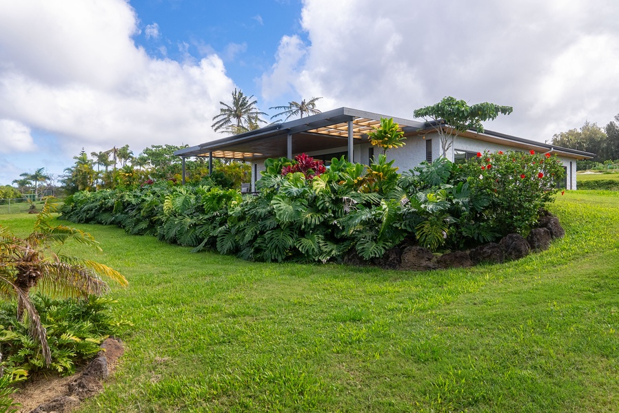 Relax in a tranquil garden setting surrounded by tropical greenery and natural privacy.
