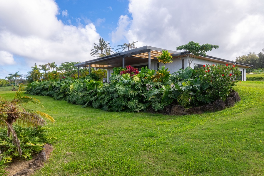 Relax in a tranquil garden setting surrounded by tropical plants and open space.