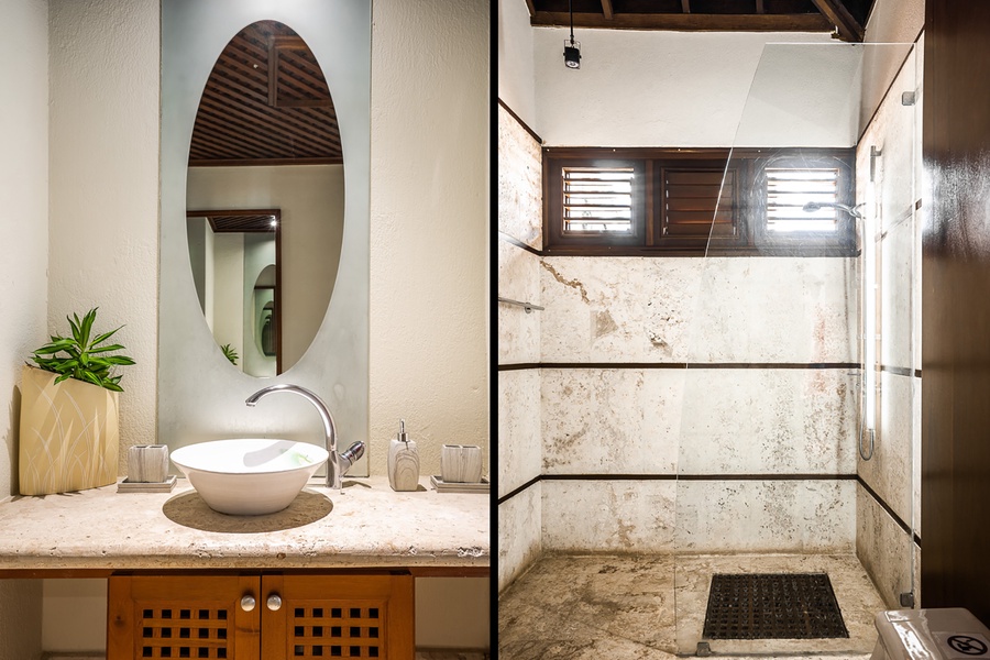The ensuite bathroom features a large walk-in shower and a single vanity.