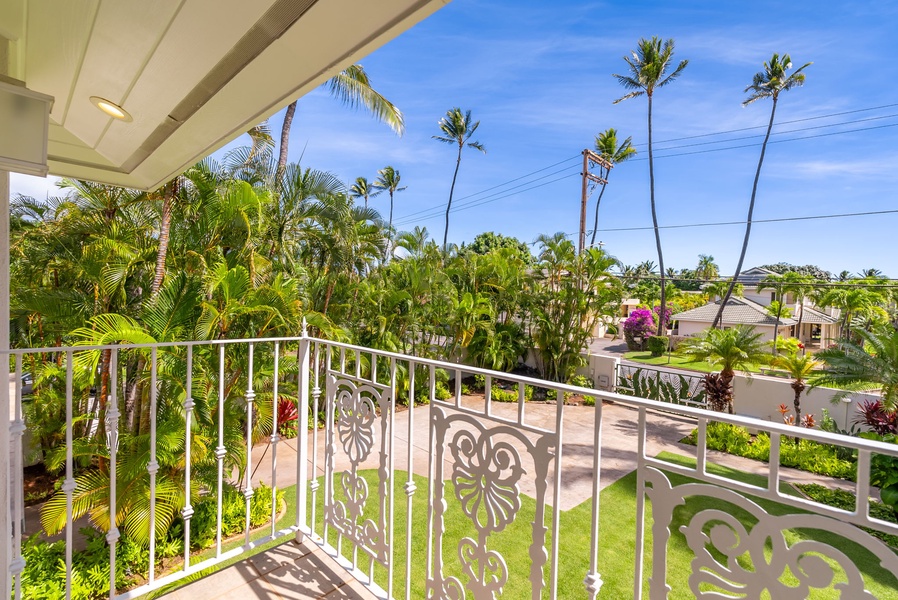 Cozy bedroom featuring a private lanai and charming garden views, perfect for a restful retreat.