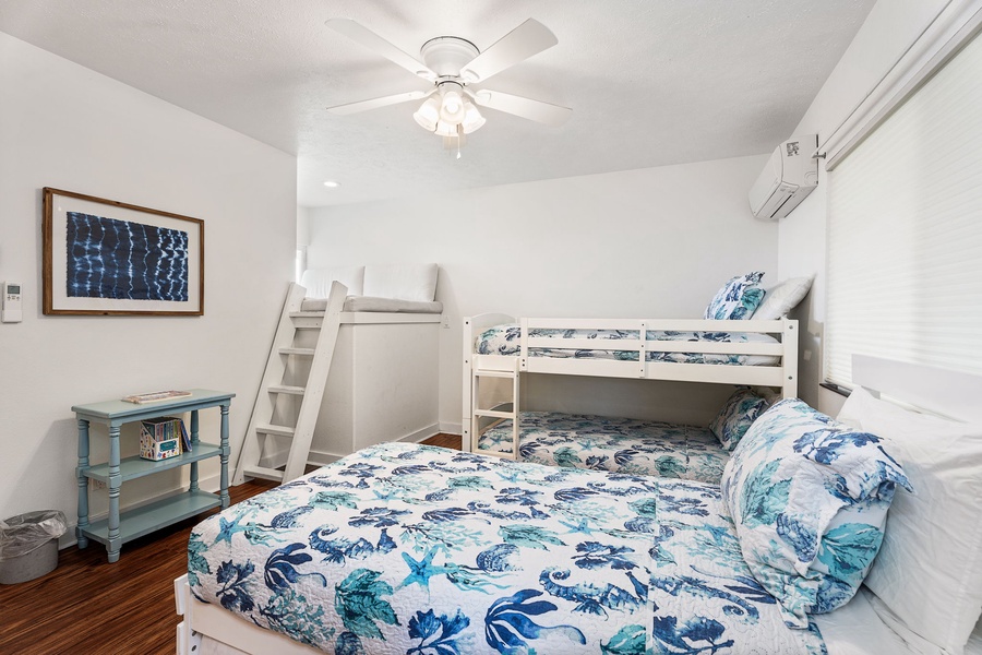 Sleep soundly in your cozy bedroom with ocean-themed linens and bunk beds perfect for families or groups.