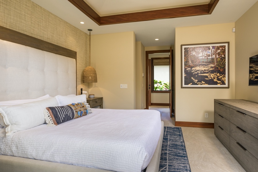 Reverse view of guest bedroom two featuring king-sized bed, wall mounted flat screen TV and valanced ceilings.