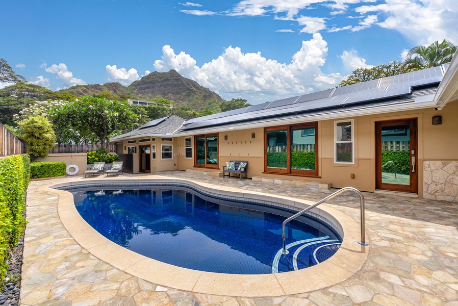 Take in sweeping Diamond Head views while lounging by your private pool in this serene backyard retreat.