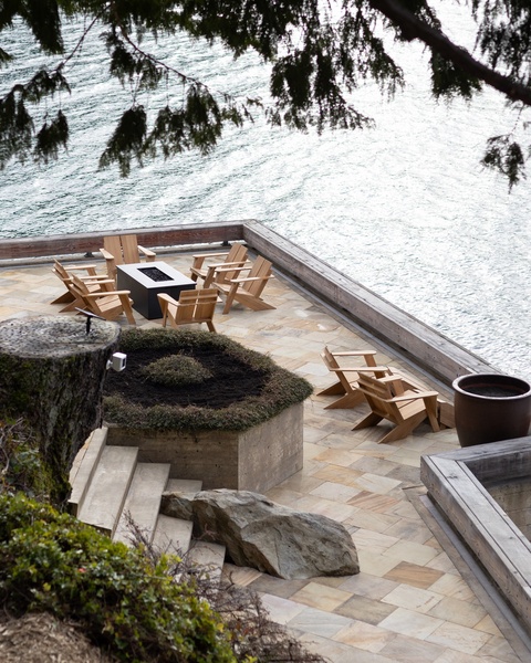 Unwind on your private waterfront terrace with Adirondack chairs and fire pit, where lake views create the perfect backdrop for relaxation.