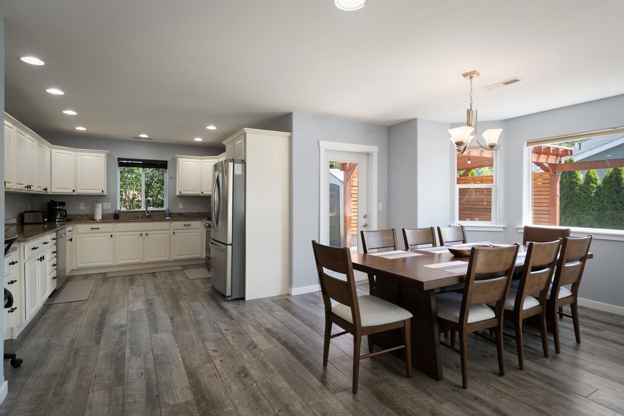 The bright open-concept floor plan offers comfortable gathering spaces filled with natural light and relaxed coastal charm.