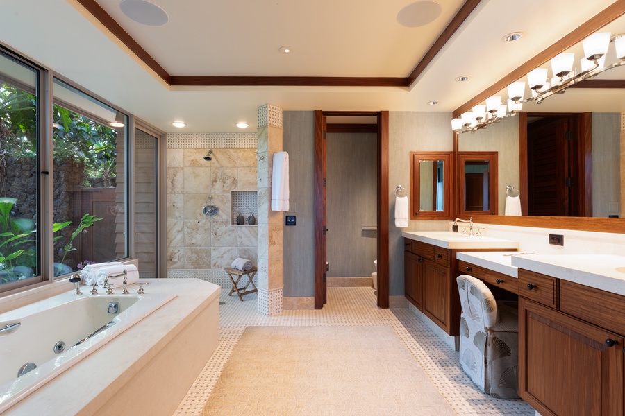 Spa-inspired bathroom with soaking tub, dual vanity, and walk-in shower.