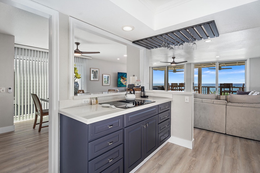 High-end kitchen with stainless appliances, breakfast bar, and wine glass rack.