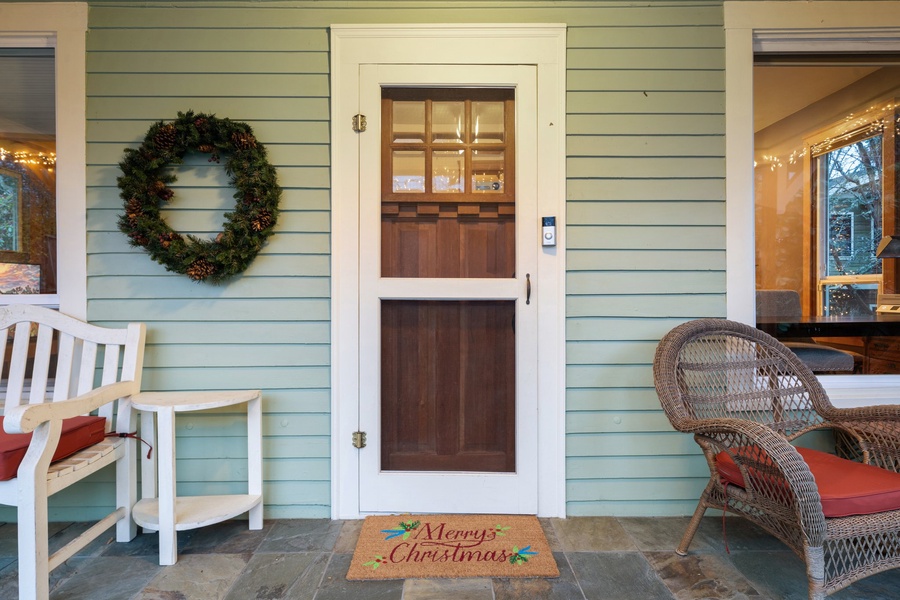 Festive front door with holiday wreaths and cozy decor, creating a warm welcome.