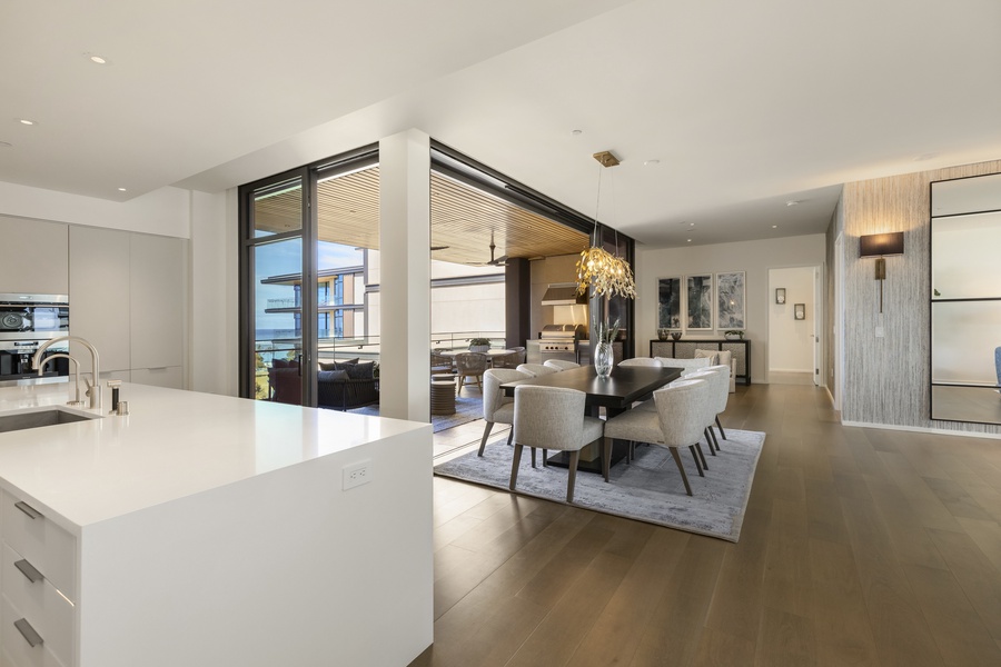The kitchen overlooks the formal dining area with peek-a-boo ocean views