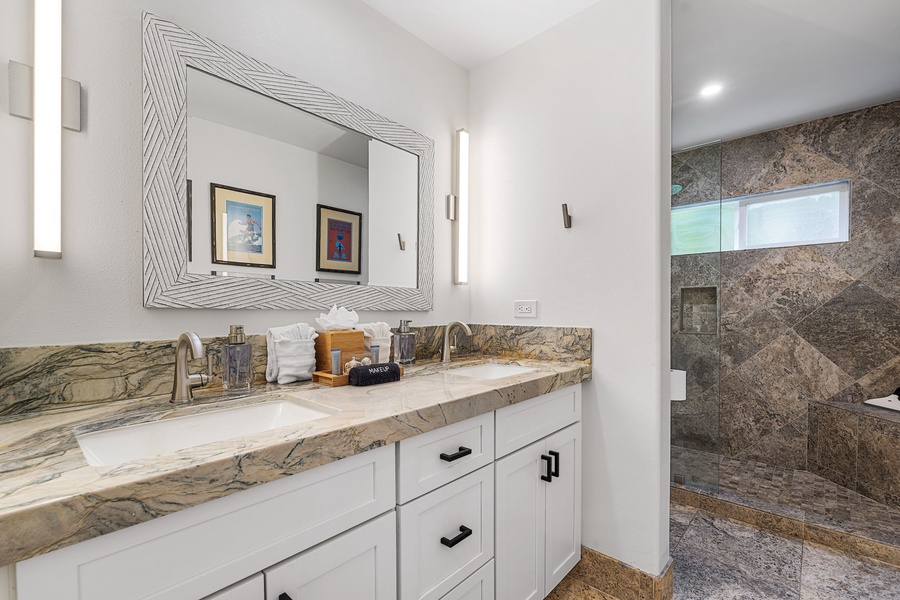 Refresh in a bright ensuite with marble counters and a spacious walk-in shower.