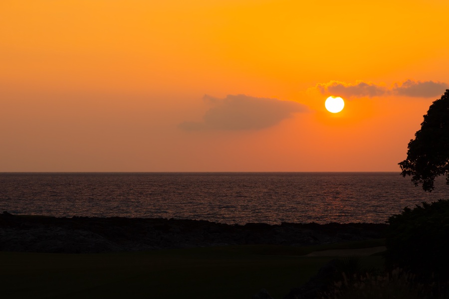 Breathtaking sunset over the ocean creates a breathtaking golden backdrop for this coastal property location.