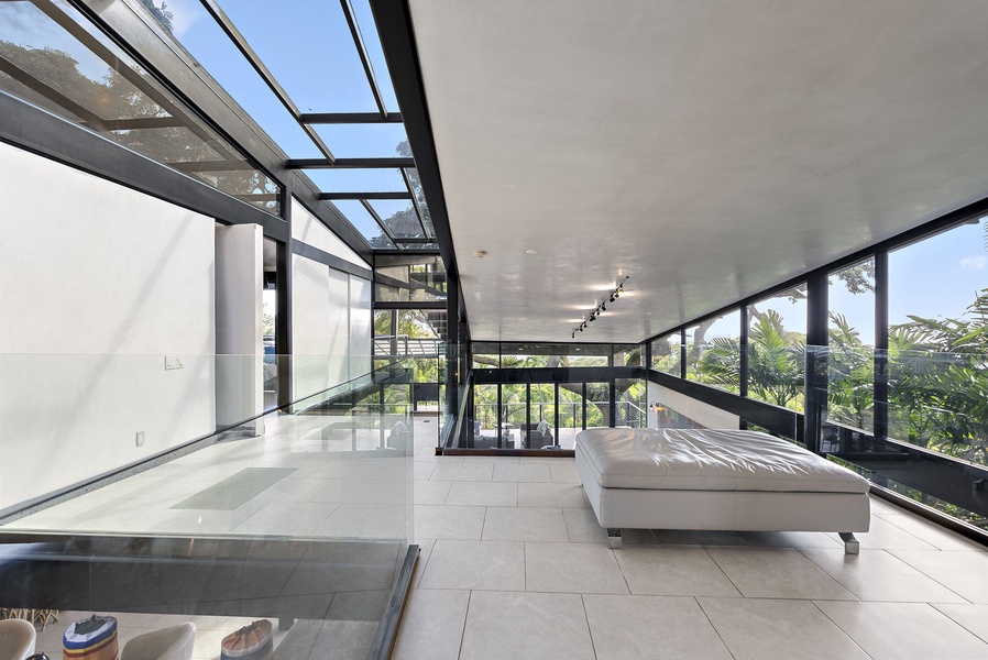 Expansive open-concept lounge with sleek interiors and lush outdoor scenery.