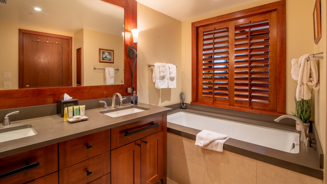 The primary guest bathroom has a walk-in shower and luxurious soaking. tub.