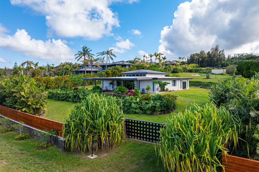 The front yard features beautiful landscaping and a lush green lawn leading to the home.