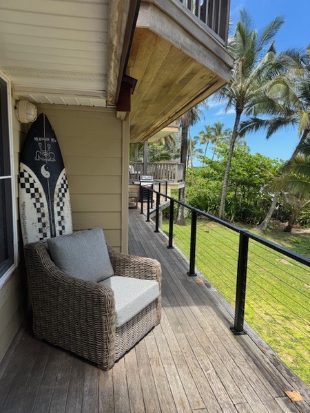 Relax on the private lanai with comfortable seating, surrounded by tropical greenery and ocean breezes.
