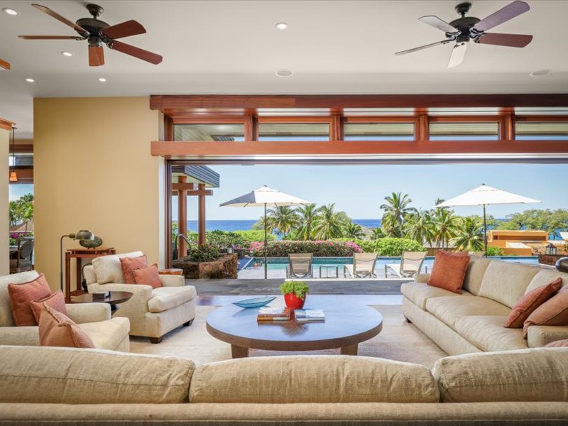 Living room has Ocean and pool view