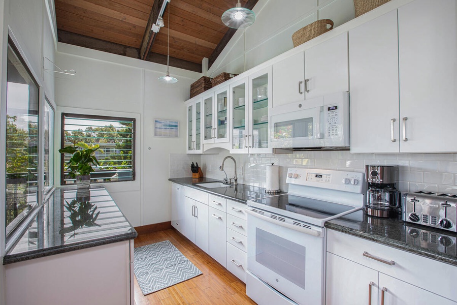 Prepare island-style meals in the fully remodeled kitchen with sleek cabinetry and modern appliances.