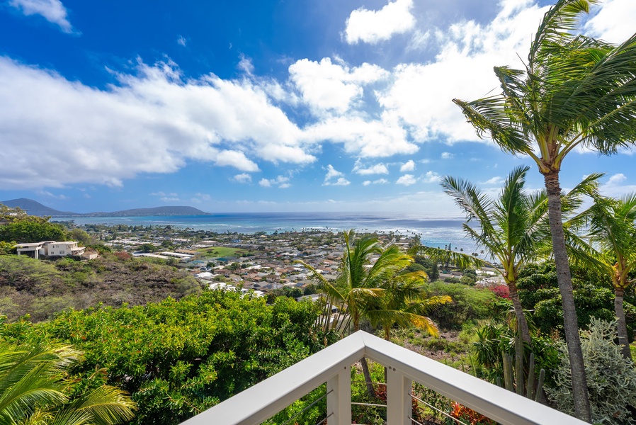 Expansive coastline and ocean views unfold from the upper-level lanai.