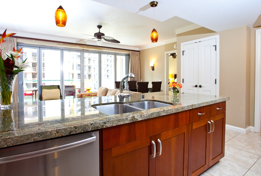 The open-concept kitchen effortlessly blends into the living area, featuring sleek granite countertops and modern appliances for a touch of everyday luxury.