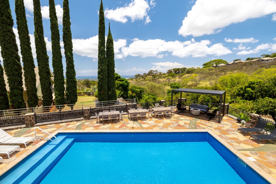 From sunrise to sunset, your private pool deck delivers panoramic hillside and ocean views framed by tall palms and native flora.