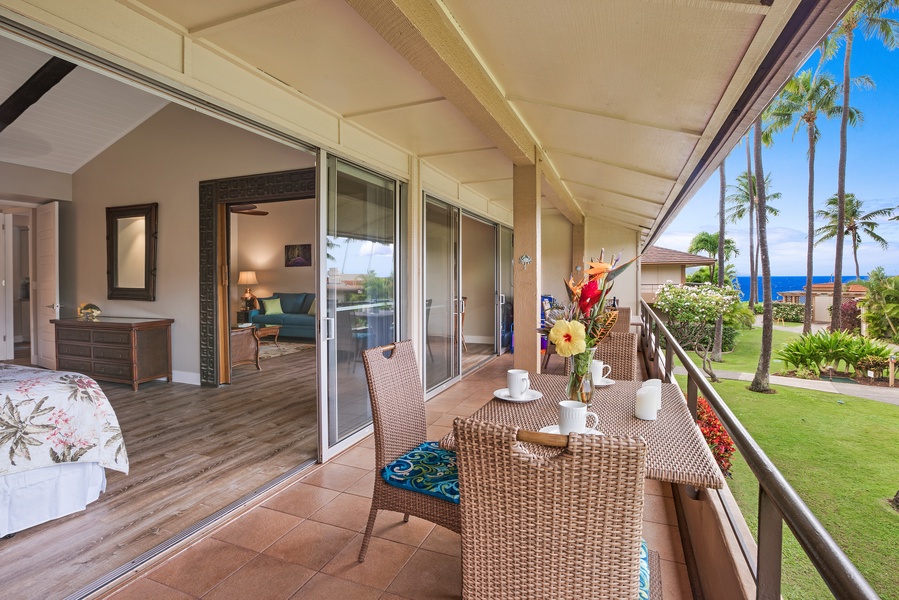 The spacious lanai offers a tranquil spot to enjoy your morning coffee or an alfresco meal, surrounded by lush greenery and views of the nearby garden