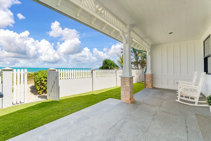This shaded terrace offers panoramic views of the beach and lush green surroundings.