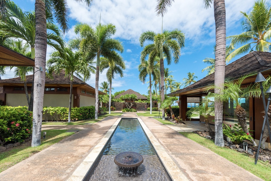 The path to the Pauoa Beach Club Amenities Center is lined with a welcoming water feature & pristine landscaping