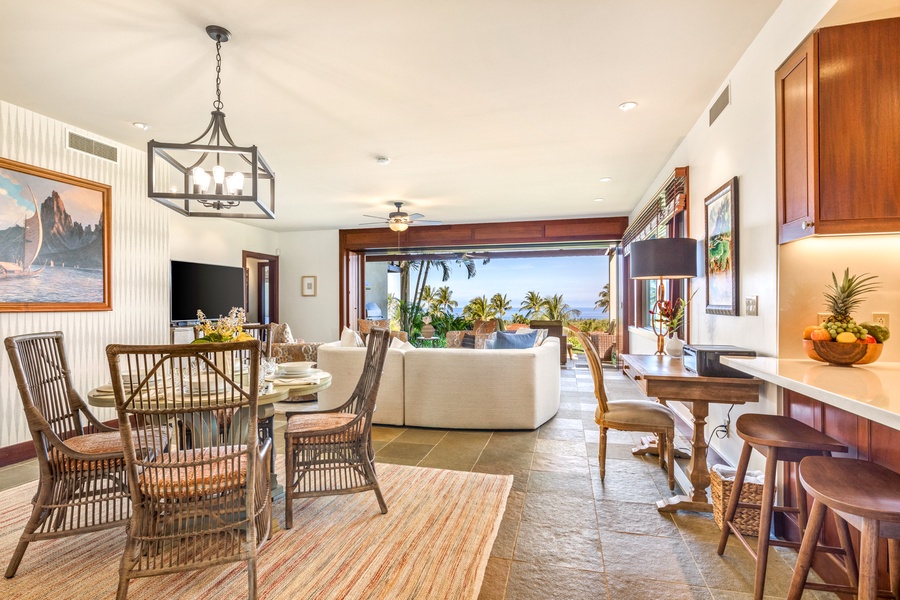 Wide view of the gorgeous open concept great room with floor to ceiling pocket doors that open completely to the lanai.