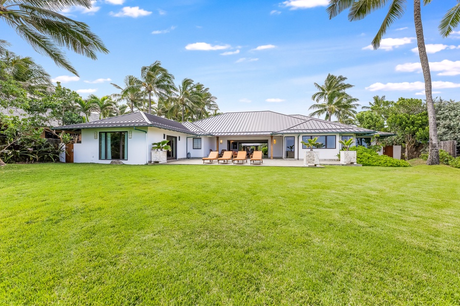 View from the back of the estate, where garden, lawn, and sea converge in quiet elegance.