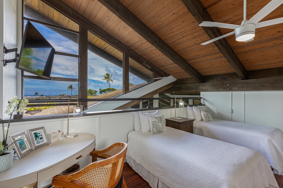 Loft with a partial ocean view and twin beds.