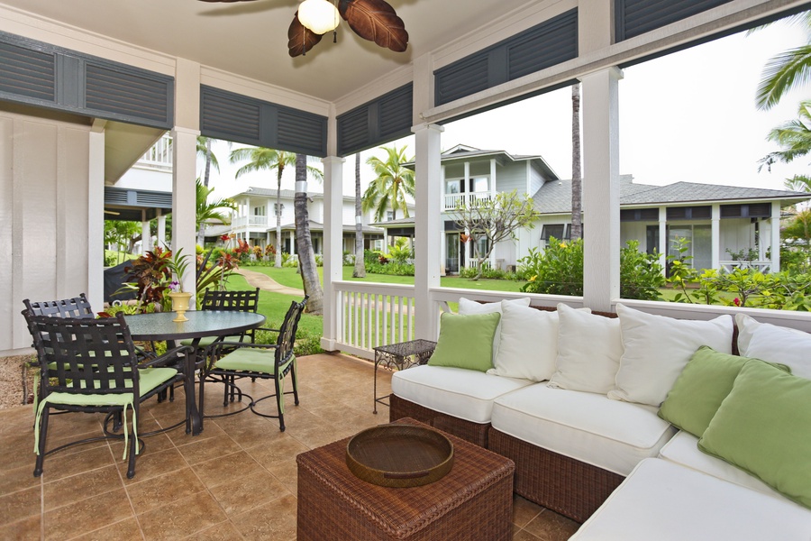 The elegant lanai with luxurious furnishings surrounded by swaying palm trees.