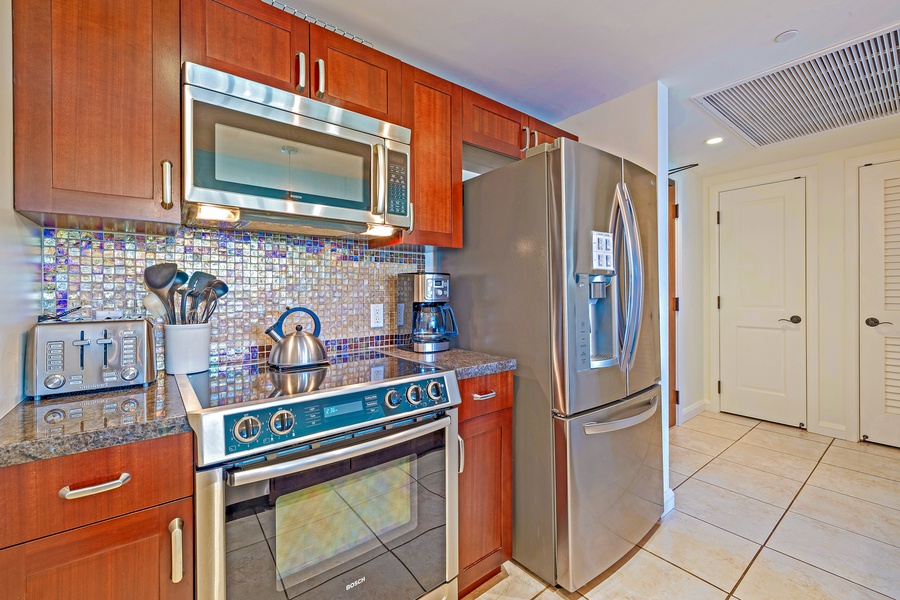 Stylish kitchen at Honua Kai Konea 206 with sleek cabinets and all your cooking needs.