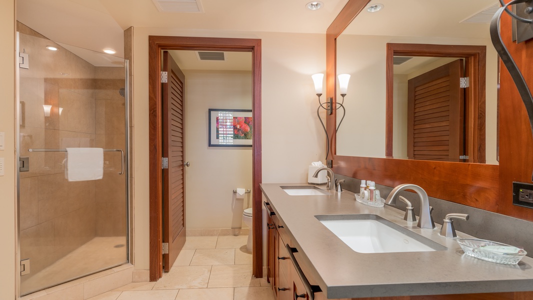 The primary guest bathroom walk-in shower and double vanity.