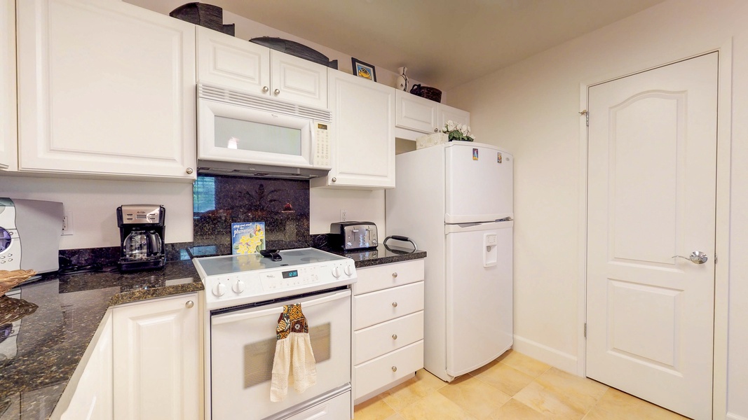Functional kitchen equipped with essential appliances and ample storage space.
