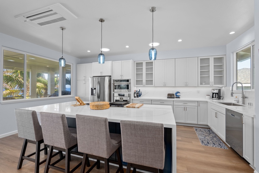 Full upstairs kitchen with walk-in pantry, oversized island, and natural light throughout.