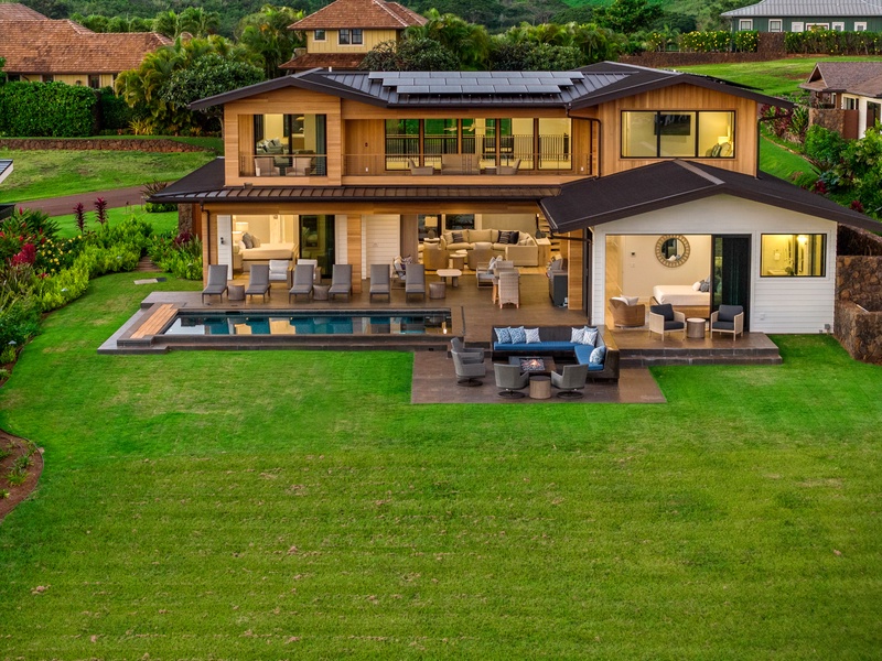 Modern luxury home featuring stunning architecture, swimming pool, and expansive outdoor entertaining spaces amid lush tropical landscaping.