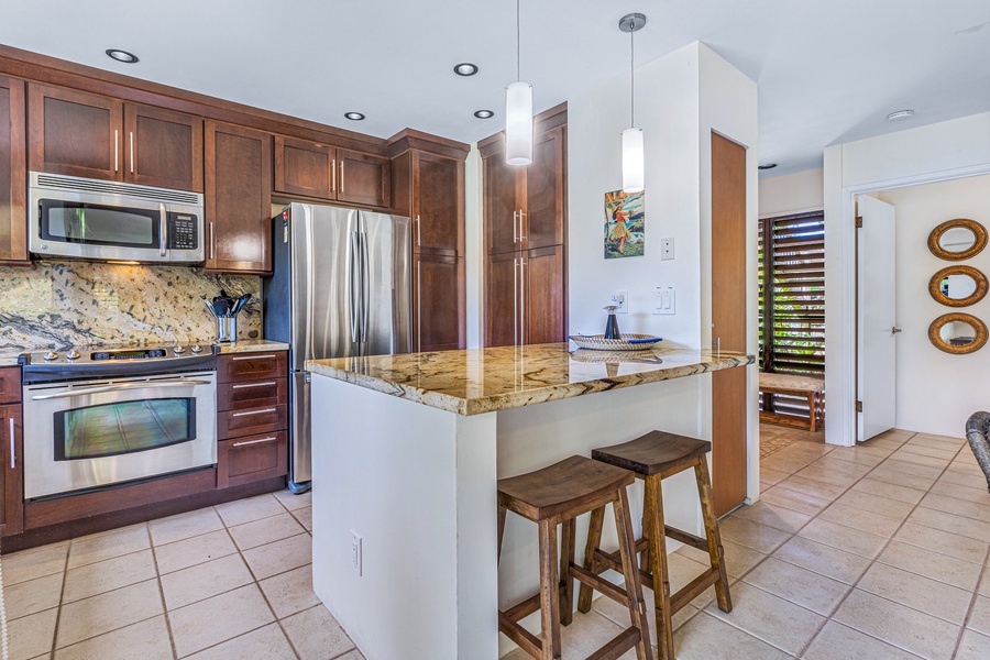 Wailea Ekolu 1605 kitchen includes a cozy breakfast bar, perfect for a quick meal or morning coffee.
