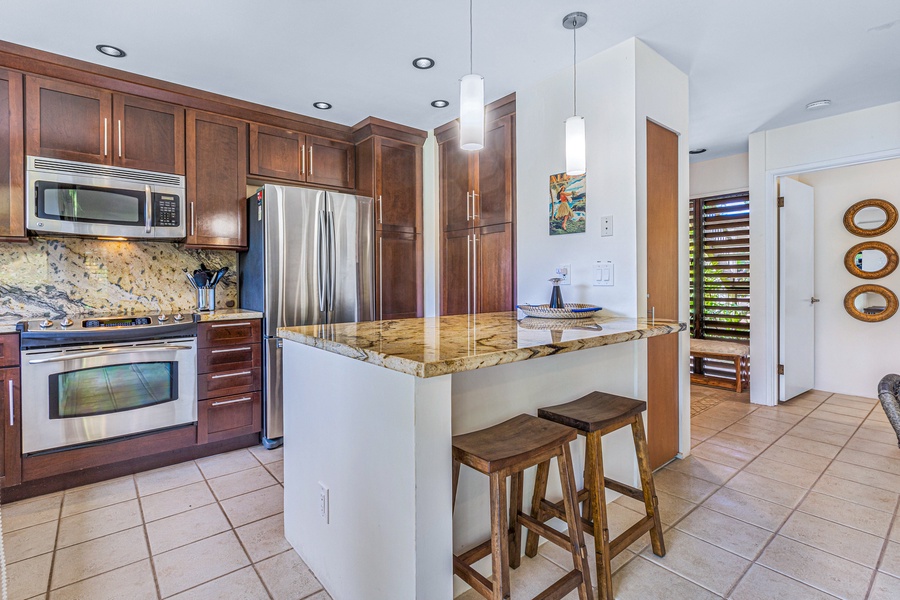 The kitchen features a cozy breakfast bar with seating for two, ideal for a quick meal or morning coffee.