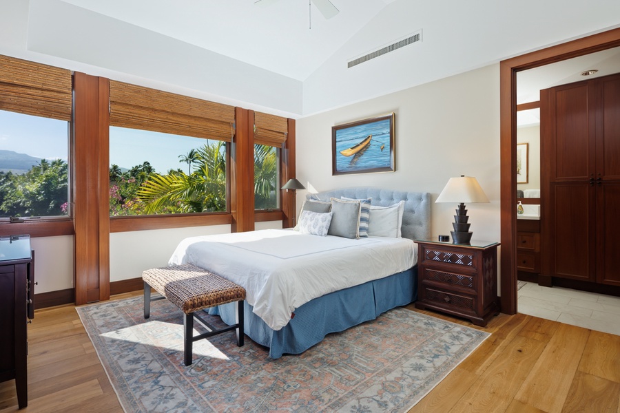 Wake up to tropical paradise through your bedroom windows, with lush palm trees creating your private island sanctuary.