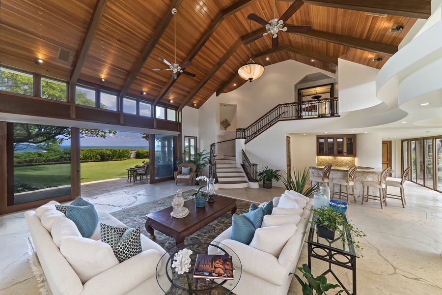 Main house: Main living room features breathtaking oceanfront views.  Follow the steps up towards the Primary Bedroom.