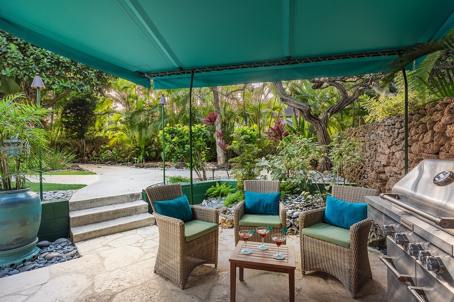 Outdoor BBQ area with cozy seating for 4, overlooking the pool for alfresco dining.