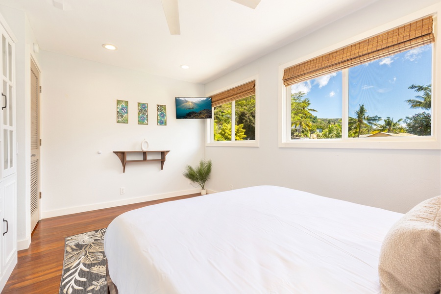 Garden views and natural light make this bedroom a relaxing retreat with privacy and charm.