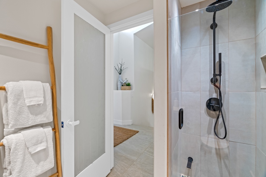 Bright, modern bathroom with sleek walk-in shower and stylish details.