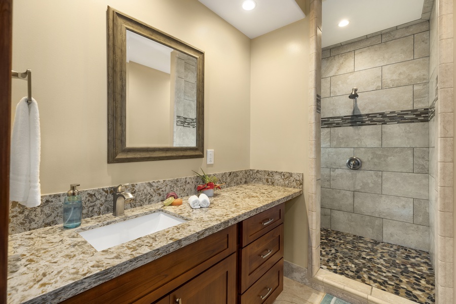 The en suite primary bath has a walk-in shower and ample counter space.